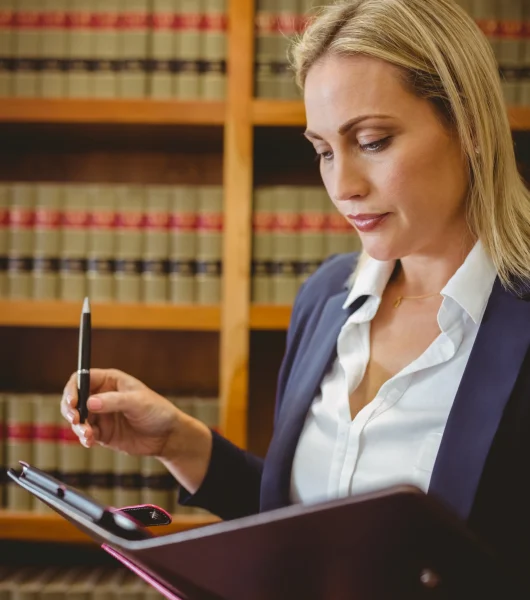 focused-female-librarian-holding-textbook-in-libra-2025-04-05-06-29-56-utc